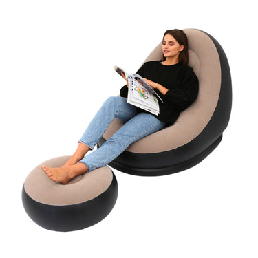 Woman sitting in a modern, inflatable chair reading a magazine on a white background